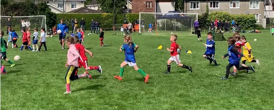 Young children playing a match at RMFC academy.